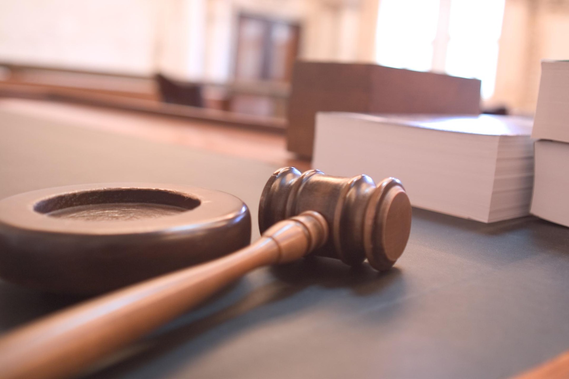 A judge's gavel resting on its sound block